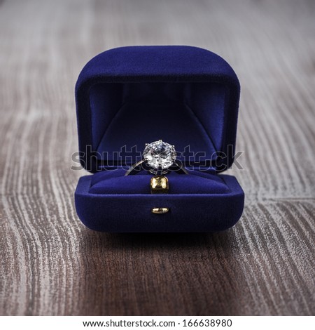 ring in the box on wooden table