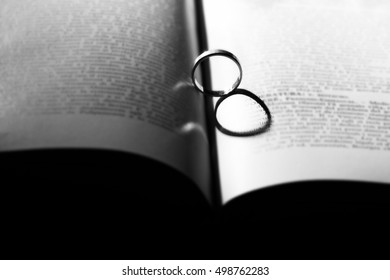 ring casting a heart-shaped shadow on the book page