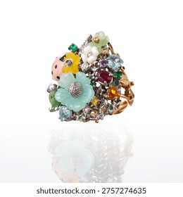 ring decorated with a ladybug and various colored flowers set with precious stones