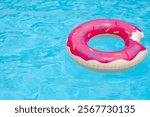 Ring float in swimming pool. Summer background. Summer backdrop. Summertime vacation. Rubber circle. Inflatable swimming ring.