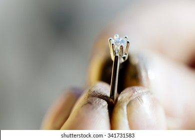 Ring held by jeweler after polishing it