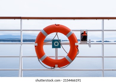 Ring life boy on big boat.Obligatory ship equipment. Orange lifesaver on the deck of a cruise ship.