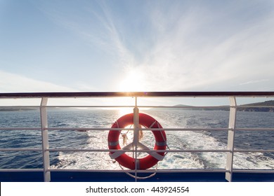 Ring life boy on big boat.Obligatory ship equipment.Personal flotation device.Prevent drowning.Orange lifesaver on the deck of a cruise ship.Traveling to an island - Powered by Shutterstock