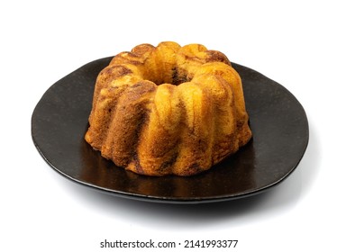 Ring marble cake isolated. Ciambella, Christmas bundt dessert, traditional pastry babka, easter sponge pie on black plate background