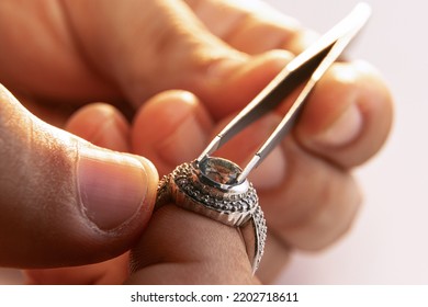 Ring repair process. Closeup hands of jeweler at work in jewelry. Desktop for craft jewelry making with professional tools. Concept of job, business, beauty, art and ad. - Powered by Shutterstock