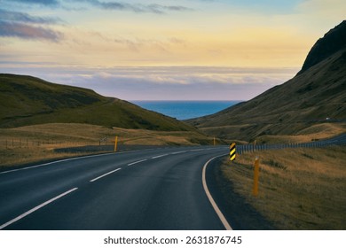 The ring road of route 1 for road trip iceland travel with sight seeing with mountain golden light and seascape on background and sunset skyline.