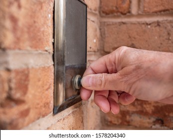 Ringing Doorbell With Thumb. Closeup Of Male Hand Pushing Home Intercom Door Bell Button.