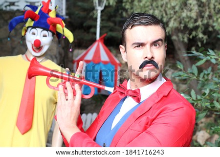 Ringmaster playing the trumpet in the circus