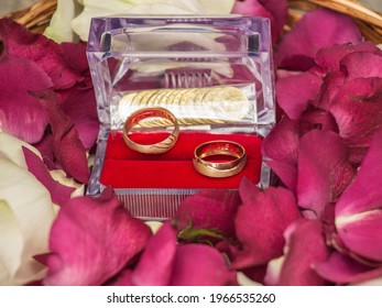 Rings And Wedding Band On Rose Petals