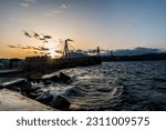 Rio Antirio bridge in Patras at the sunset on a beautiful evening with waves at the dock of Rio.