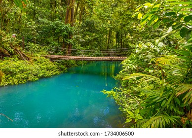 Rio Celeste with turquoise, blue water and small wooden bridge Tenorio national park Costa Rica. Central America.