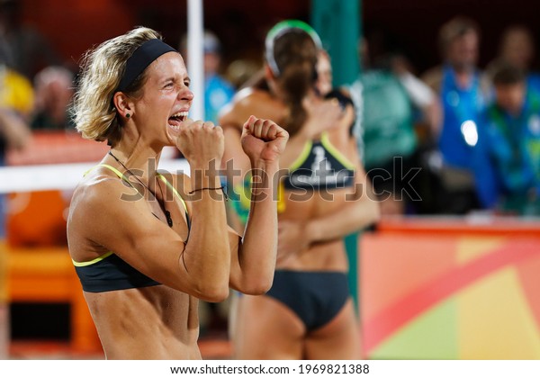 Rio de Janeiro, Brazil 08.17.2016: Laura Ludwig and\
Kira Walkenhorst of Germany beach volleyball team score gold medal\
final match at Rio 2016 Olympic Games. German players win over\
brazilian team.