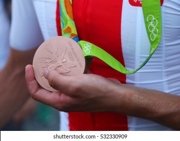 RIO DE JANEIRO, BRAZIL - AUGUST 6, 2016: Bronze Medalist Rafal Majka Of Poland Holds Olympic Bronze Medal After Men Cycling Road Medal Ceremony Of The Rio 2016 Olympic Games  