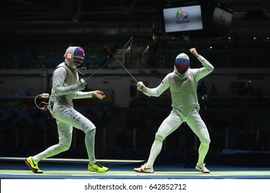 RIO DE JANEIRO, BRAZIL - AUGUST 12, 2016: Fencer Of Team USA (L) Competes Against Team Russia Fencer In The Men's Team Foil Of The Rio 2016 Olympic Games At The Carioca Arena 3