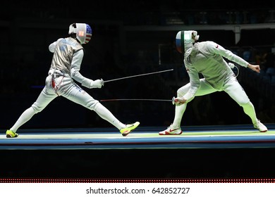 RIO DE JANEIRO, BRAZIL - AUGUST 12, 2016: Fencer Of Team USA (L) Competes Against Team Russia Fencer In The Men's Team Foil Of The Rio 2016 Olympic Games At The Carioca Arena 3