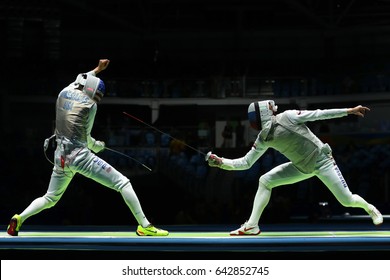 RIO DE JANEIRO, BRAZIL - AUGUST 12, 2016: Fencer Of Team USA (L) Competes Against Team Russia Fencer In The Men's Team Foil Of The Rio 2016 Olympic Games At The Carioca Arena 3