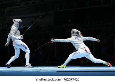 RIO DE JANEIRO, BRAZIL - AUGUST 13, 2016: Dagmara Wozniak Of United States (R) And Ekaterina Dyachenko Of Russia Compete In The Women's Sabre Team Of The Rio 2016 Olympic Games At Carioca Arena 3