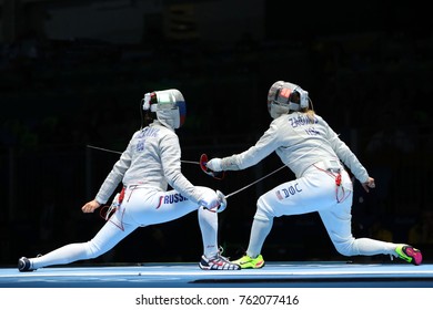 RIO DE JANEIRO, BRAZIL - AUGUST 13, 2016: Dagmara Wozniak Of United States (R) And Ekaterina Dyachenko Of Russia Compete In The Women's Sabre Team Of The Rio 2016 Olympic Games At Carioca Arena 3