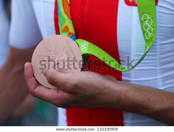 RIO DE JANEIRO,\
BRAZIL - AUGUST 6, 2016: Bronze medalist Rafal Majka of Poland\
holds Olympic bronze medal after men Cycling Road medal ceremony of\
the Rio 2016 Olympic Games \
