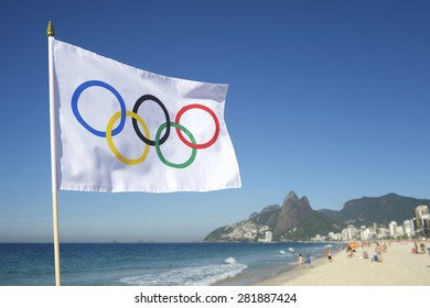 RIO DE JANEIRO, BRAZIL - FEBRUARY 12, 2015: An Olympic flag flies above the city skyline at Ipanema Beach with a view of Two Brothers Mountain.