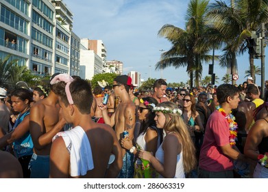 RIO DE JANEIRO, BRAZIL - FEBRUARY 07, 2015: Crowd Of Young Brazilians Celebrate At Carnival Street Party On A Sunny Summer Afternoon Along Ipanema Beach.