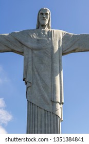 Rio De Janeiro, Brazil - July 12, 2017: Close Up Shot Of Christ The Redeemer Statue On The Corcovado Mountain In Rio De Janeiro On A Bright Sunny Day With Blue Sky