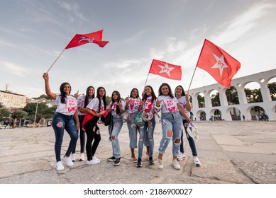 Rio De Janeiro, Brazil - July 7, 2022: Group Of Young Female Workers Party (PT) Supporters With Flags In The Air.