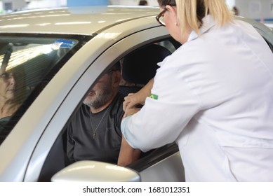 RIO DE JANEIRO, BRAZIL, MARCH, 23, 2020:flu Vaccination In Elderly People Using The Drive Thru System Receive The Vaccine Inside The Car To Prevent Crowding Due To The Coronavirus, Covid19