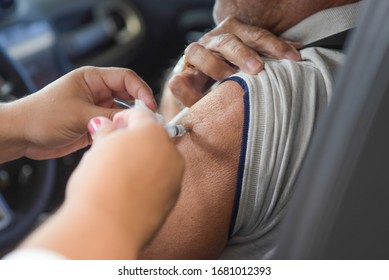 RIO DE JANEIRO, BRAZIL, MARCH, 23, 2020:flu Vaccination In Elderly People Using The Drive Thru System Receive The Vaccine Inside The Car To Prevent Crowding Due To The Coronavirus, Covid19