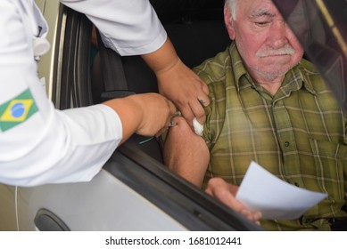 RIO DE JANEIRO, BRAZIL, MARCH, 23, 2020:flu Vaccination In Elderly People Using The Drive Thru System Receive The Vaccine Inside The Car To Prevent Crowding Due To The Coronavirus, Covid19