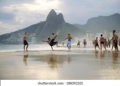RIO DE JANEIRO, BRAZIL - MARCH 20, 2014: Brazilian man does a bicycle kick during a game of keepie-uppie football (known locally as altinho) on the shore of Ipanema Beach.