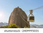 Rio de janeiro Brazil. Sugarloaf Mountain. Cable car crossing to Urca hill. In the background, the mountains and the beach of Niterói.