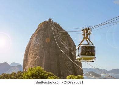 Rio de janeiro Brazil. Sugarloaf Mountain. Cable car crossing to Urca hill. In the background, the mountains and the beach of Niterói. - Powered by Shutterstock