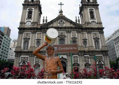 Rio De Janeiro, December 2, 2010.
Street Dweller Taking A Shower In Front Of The Candelária Church In Downtown Rio De Janeiro, Brazil