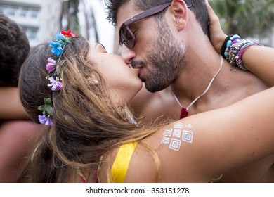 RIO DE JANEIRO - FEBRUARY 14, 2015: A Young Brazilian Couple Kiss, Oblivious To The Crowd Of People Around Them, During A Carnival Street Party In Ipanema.