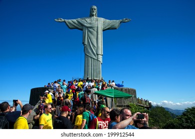 RIO DE JANEIRO, JUNE 12: Tourists on the Corcovado Hill visiting the Christ Redeemer with their national team jerseys the day the 2014 FIFA World Cup began  - June 12, 2014 in Rio de Janeiro, Brazil 