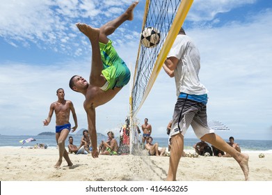 RIO DE JANEIRO - MARCH 17, 2016: Young Brazilian man performs a bicicleta (bicycle kick) in a game of futevôlei (footvolley, a sport that combines football and volleyball) on Ipanema Beach. 