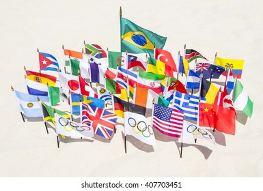 RIO DE JANEIRO - MARCH 20, 2015: Olympic flags fly together with an array of Brazil and international flags on the sand of Ipanema Beach in anticipation of the city hosting the Summer Games.