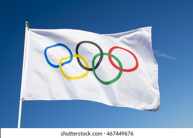 RIO DE JANEIRO - MARCH 27, 2016: An Olympic flag flutters in the wind against bright blue sky in celebration of the city hosting the Summer Games.