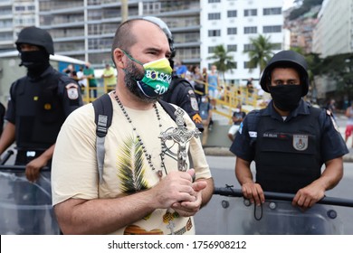Rio de Janeiro, RJ / Brazil - June 07 2020 - Pubic march in Copacabana, South Zone of Rio de Janeiro city, in favour of Brazilian president Jair Bolsonaro. Man with Brazilian flag mask protesting.