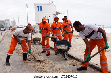 Rio de Janeiro, RJ / Brazil - April 15 2020 - Street sweepers in Leblon, South Zone of Rio de Janeiro, working on the beach promenade after sea surf. Street sweepers working.