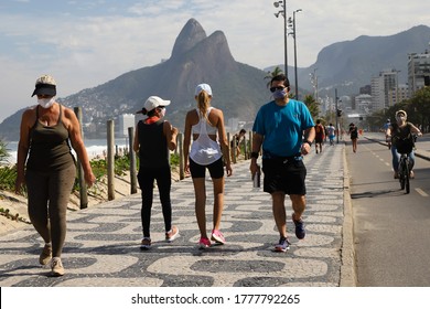 Rio de Janeiro, RJ / Brazil - June 27 2020 -Ipanema and Leblon beach, South Zone of Rio de Janeiro city. State government loosening isolation. People walking along the beach boardwalk.