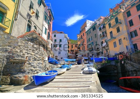 Riomaggiore harbor with wooden boats and traditional buildings, Cinque Terre, Italy