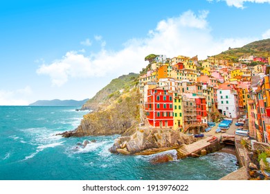 Riomaggiore on the mountain in cinque terre near mediterranean sea in Liguria - Italy and sunny cloudy sky, traditional italian architecture