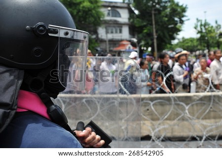 A Riot Police Officer Stands Guard During a Political Protest