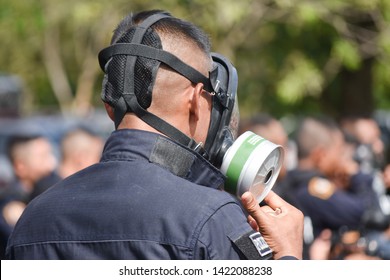 Riot Police Using Tear Gas Mask And Training With Crowd.