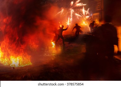 Riots in the city, citizens in conflict with the power harness tires and vehicles police disperse demonstrators in Europe, protesting people fighting for their rights, is also breaking the law - Shutterstock ID 378575854