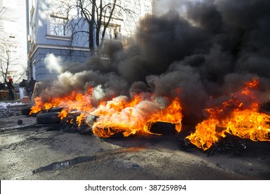 Riots in the city, citizens in conflict with the power harness tires and vehicles police disperse demonstrators in Europe, protesting people fighting for their rights, is also breaking the law - Shutterstock ID 387259894