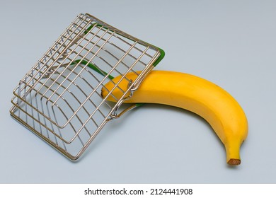 Ripe Banana Lies In A Miniature Grocery Basket. High Quality Photo