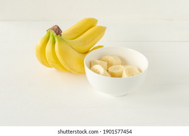 Ripe Bananas Cut In White Bowl For Eating. Healthy Snack Or Breakfast Concept.